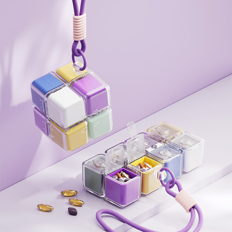 A portable medication organizer designed in the shape of a Rubik's Cube, featuring a lanyard for convenient carrying, a high-capacity dispensing compartment, and a sealed, moisture-resistant storage container organized for daily use across seven days.