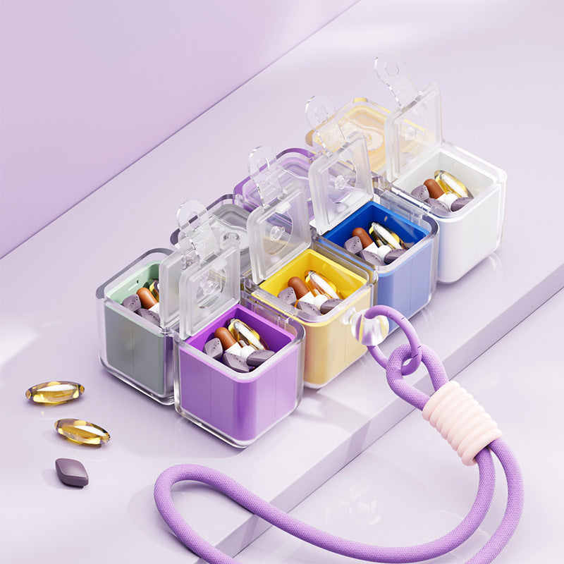 A portable medication organizer designed in the shape of a Rubik's Cube, featuring a lanyard for convenient carrying, a high-capacity dispensing compartment, and a sealed, moisture-resistant storage container organized for daily use across seven days.