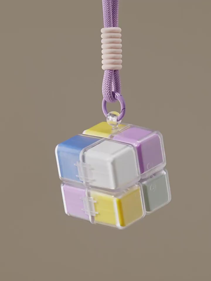 A portable medication organizer designed in the shape of a Rubik's Cube, featuring a lanyard for convenient carrying, a high-capacity dispensing compartment, and a sealed, moisture-resistant storage container organized for daily use across seven days.